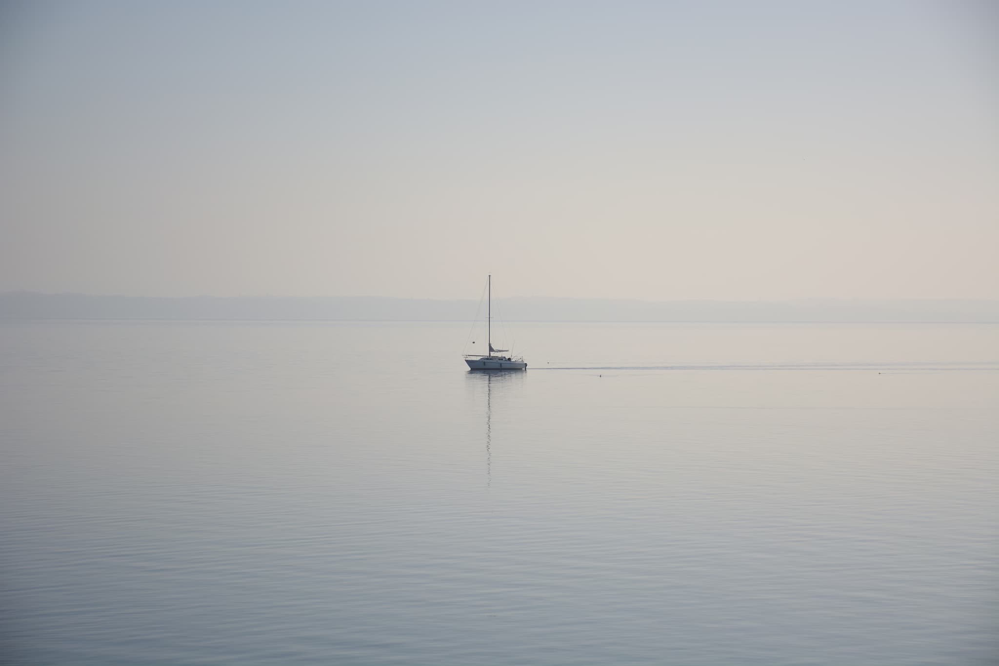 Lonely sailboat on lake Neuchâtel
