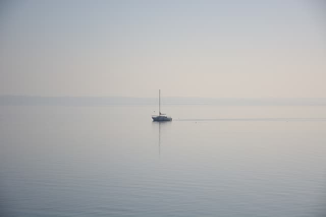 Lonely sailboat on lake Neuchâtel